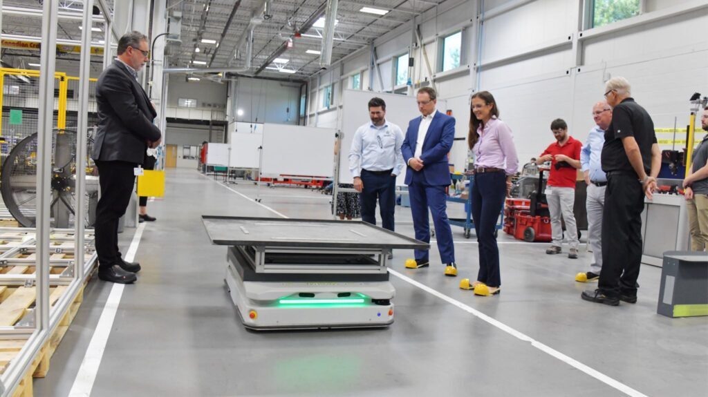 Minister Stephen Crawford and MPP Andrea Khanjin tour Innovative Automation’s facility while observing an Autonomous Mobile Robot (AMR) in operation, showcasing advanced manufacturing technology in Ontario.