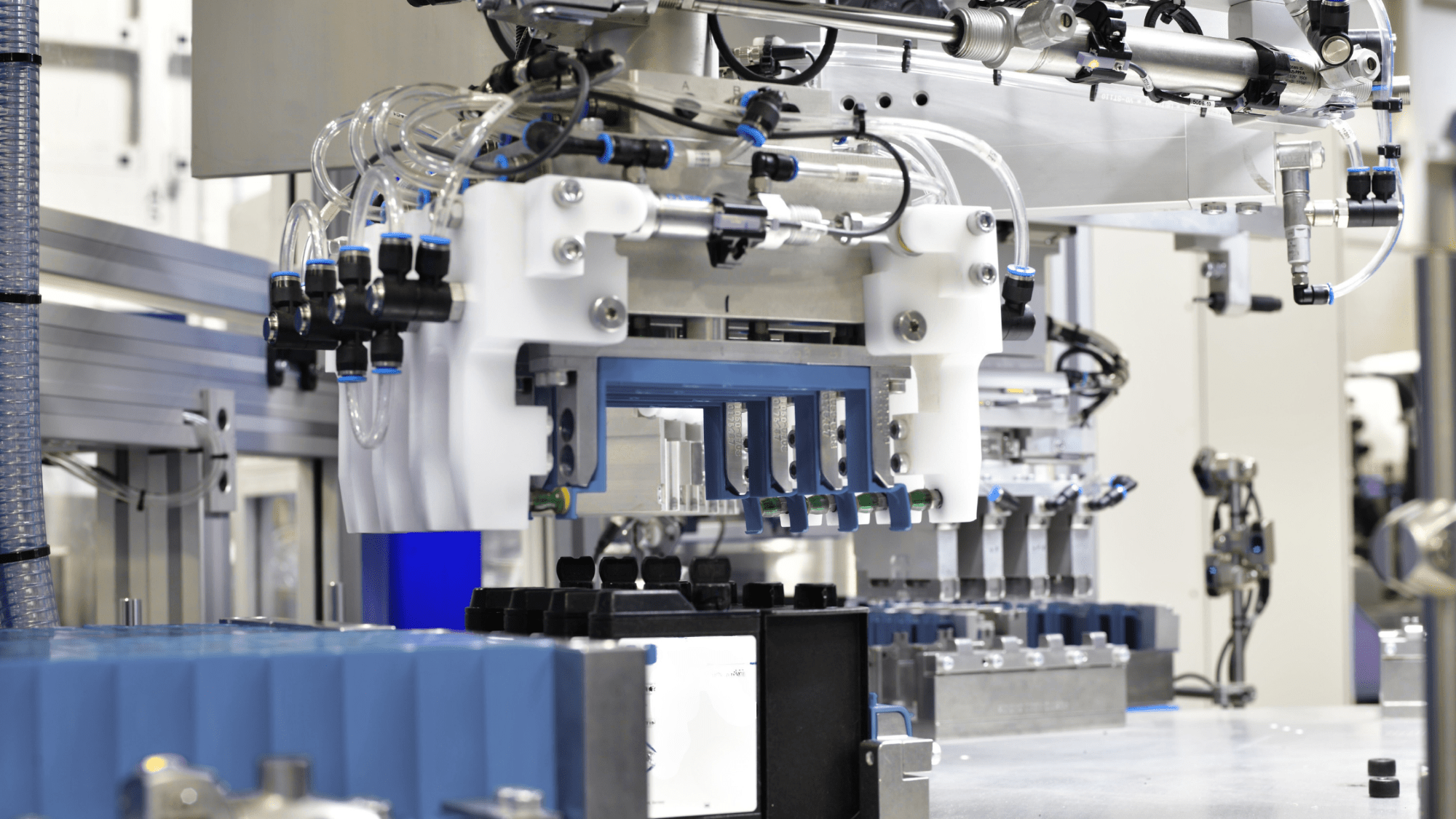 Innovative Automation engineer inspecting an industrial robotic arm during system integration at our Barrie, Ontario facility.